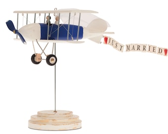A plane on a stand, centerpieces for wedding table. Wooden plane with figurines of newlyweds with banner just married. Bridal shower gift.