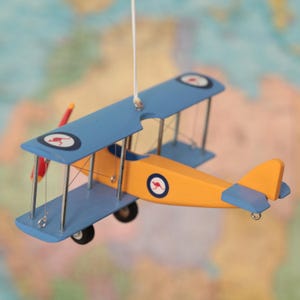 Hanging airplane with Military aircraft insignia. Model biplane. Kids room aviation decor. Gift for Veterans. Yellow blue. Nostalgic decor