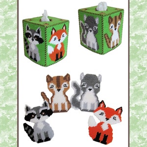 May include: Two tissue box covers with a green background and a fox and raccoon design. There are also four individual appliques of a fox, raccoon, and two squirrels.