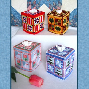 May include: Four decorative tissue box covers in various colours and patterns. The designs include stars, leaves, and floral motifs. Each box has a square shape with a hole for tissue dispensing.