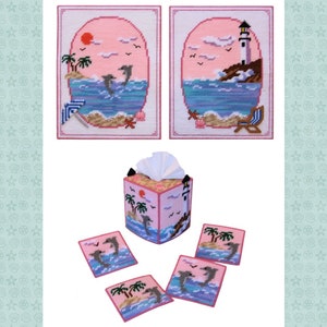 May include: A set of pink and blue needlepoint crafts featuring a beach scene with dolphins, palm trees, and a lighthouse. The set includes two wall hangings, a tissue box cover, and four coasters.