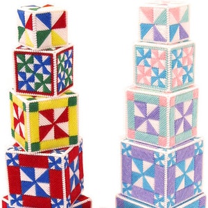 May include: A set of colorful, patterned fabric blocks stacked in two towers. The blocks are made of a soft, textured fabric and feature a variety of geometric designs. The blocks are perfect for children to play with and learn about colors and shapes.