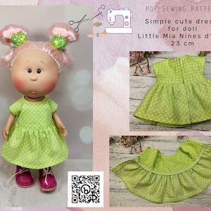 May include: A PDF sewing pattern for a simple, cute dress for a 23 cm doll. The dress is green with white polka dots and has a ruffled bottom. The pattern is for the Little Mia Nines d'Onil doll.
