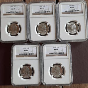 May include: Five 1955 25C MS 65 graded coins in protective cases. Each coin features a profile of a person on one side. The cases have labels with the year, grade, and serial numbers. The coins are displayed on a brown surface.