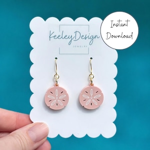 May include: A pair of light pink, circular sand dollar earrings with white etched details, suspended from gold-toned metal hooks. The earrings are displayed on a white scalloped card featuring the text Keeley Design Jewelry and Instant Download.