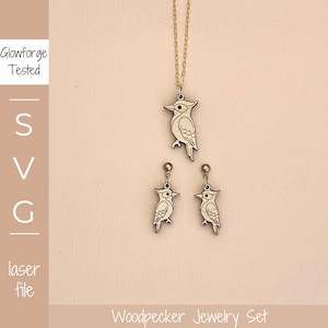 May include: A wooden woodpecker jewelry set, including a pendant necklace and matching earrings. The pendant and earrings feature a detailed woodpecker design. The set is displayed on a light pink background. The text "Woodpecker Jewelry Set" is at the bottom.