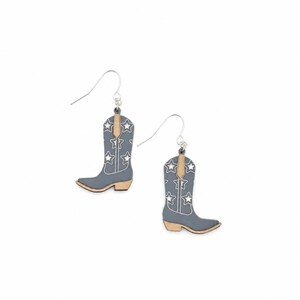May include: A pair of dangle earrings shaped like cowboy boots. The boots are matte gray with white star outlines and white stitching details. The pull straps and heels are a natural light tan wood color. Each earring hangs from a silver hook.