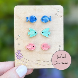 May include: Three pairs of fish-shaped stud earrings displayed on a light wood card. The top pair is blue with white stripes, the middle pair is light green, and the bottom pair is pink. The card features printed bubbles and text Instant Download.