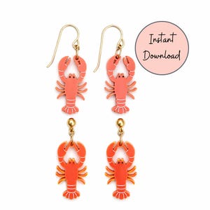 May include: Four pairs of lobster earrings. Two pairs have gold-colored fish hooks, and two pairs have gold-colored ball studs. The lobsters are coral-colored with white and yellow accents. The image includes a pink circle with the words "Instant Download".