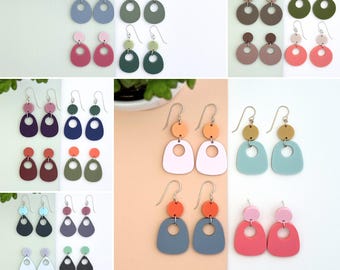 May include: A set of 10 SVG files for creating geometric shape earrings. The earrings are in various colors, including pink, blue, green, orange, and white. The earrings are designed with a simple, modern aesthetic.
