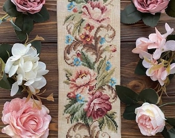 Könnte beinhalten: Eine Vintage-Blumentapete mit beigefarbenem Hintergrund und bunten Blumen, gerahmt in einem goldenen Metallrahmen mit einem Ring unten.