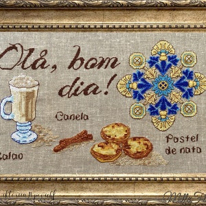 May include: Embroidered cross-stitch design featuring a cup of coffee, cinnamon sticks, and pastel de nata pastries. The design includes the Portuguese phrase "Olá, bom dia!" which translates to "Hello, good morning!" in English.