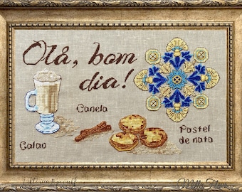Puede incluir: Diseño de punto de cruz bordado que presenta una taza de café, palitos de canela y pasteles de nata. El diseño incluye la frase portuguesa "Olá, bom dia!" que se traduce como "¡Hola, buenos días!" en español.