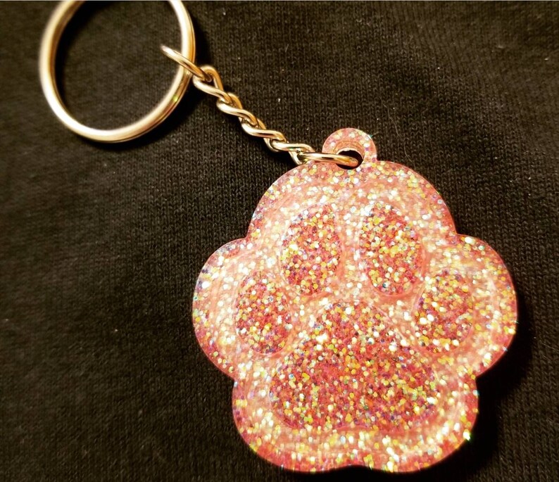 Carry the love for your pet with your keys! Glitter Paw Keychain Many color options