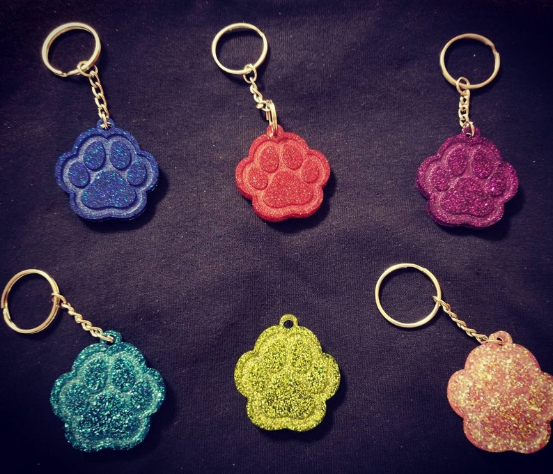 Carry the love for your pet with your keys! Glitter Paw Keychain Many color options