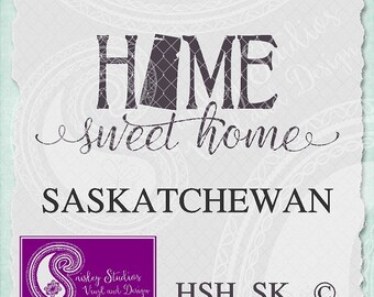 May include: A black and white graphic design with the text "HOME sweet home" and "SASKATCHEWAN" in a bold font. The graphic also includes a stylized outline of the province of Saskatchewan. The text "HSH_SK" and a copyright symbol are in the bottom right corner. The graphic is on a light blue background with a paisley pattern.