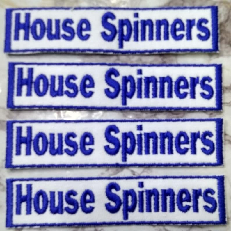 May include: Four white rectangular patches with blue embroidered text that reads "House Spinners".