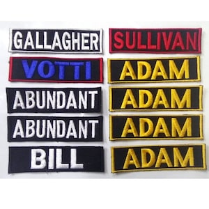 May include: Eight embroidered patches with various names, including Gallagher, Sullivan, Votti, Adam, Abundant, and Bill. The patches are black with white, red, blue, and gold lettering.