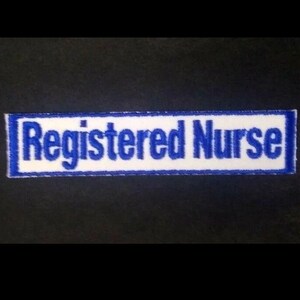 May include: Blue and white embroidered patch with the text "Registered Nurse".