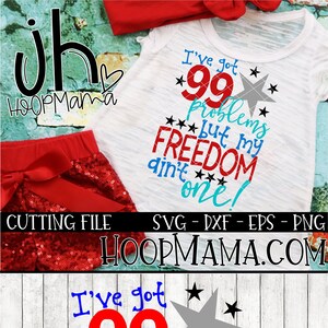 May include: Red, white, and blue graphic design with the text "I've got 99 problems but my freedom ain't one!" with a star design. The design is on a white t-shirt with a red bow.