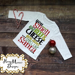 May include: White long-sleeved shirt with green, red, and black text that reads "You smell like beef & cheese... you don't smell like Santa!"