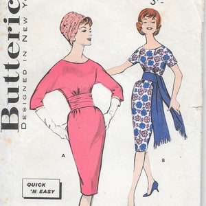 May include: Vintage Butterick sewing pattern with two dress designs. One is a solid pink dress with a cinched waist, the other a floral print with a blue sash. The pattern includes the text "Quick 'N Easy".