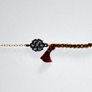 Gold-plated bracelet with micro Hematite, silk tassel and silver aged flower paved zircons image 1