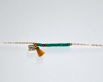 Gold plated bracelet, micro turquoises, clover with zircons and yellow ocher silk tassel