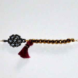 Gold-plated bracelet with micro Hematite, silk tassel and silver aged flower paved zircons image 2