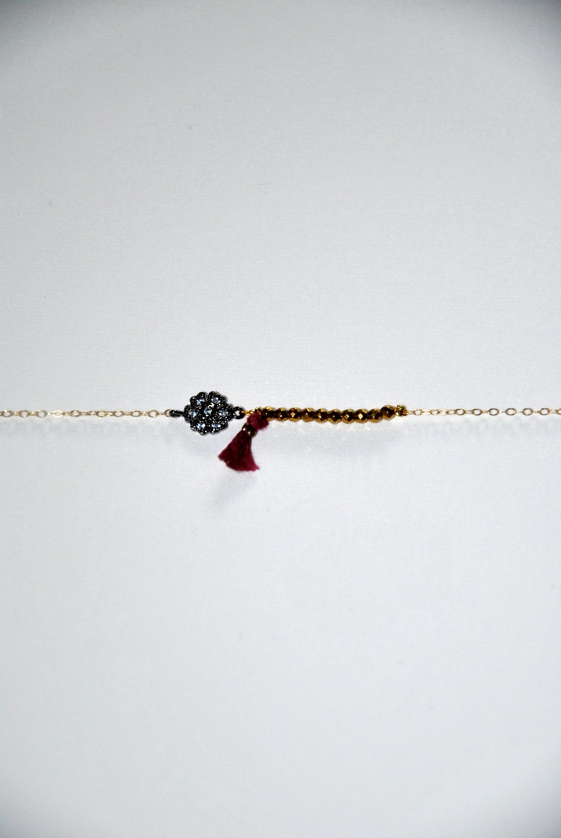 Gold-plated bracelet with micro Hematite, silk tassel and silver aged flower paved zircons image 1