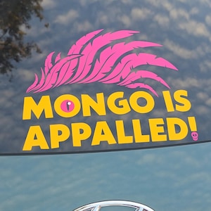 May include: A vinyl decal featuring a bright pink stylized feather design above the yellow text "MONGO IS APPALLED!" with a pink cat-like eye replacing the letter O and a small pink skull icon at the end of the exclamation point.