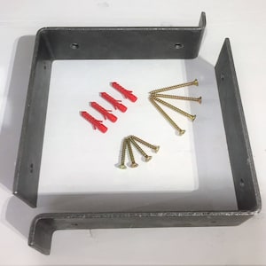 May include: Two metal brackets with four red plastic anchors and six gold screws. The brackets are designed for mounting a shelf or other object to a wall.