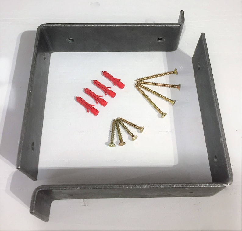 May include: Two metal brackets with four red plastic anchors and six gold screws. The brackets are designed for mounting a shelf or other object to a wall.