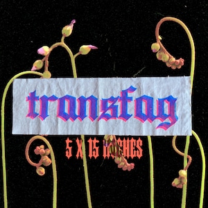 May include: A white fabric patch with the word "transfog" in pink and blue lettering. The text is in a gothic font style. Below the text is the phrase "5 x 15 inches" in red lettering. The patch is surrounded by green vines with pink and purple flowers.