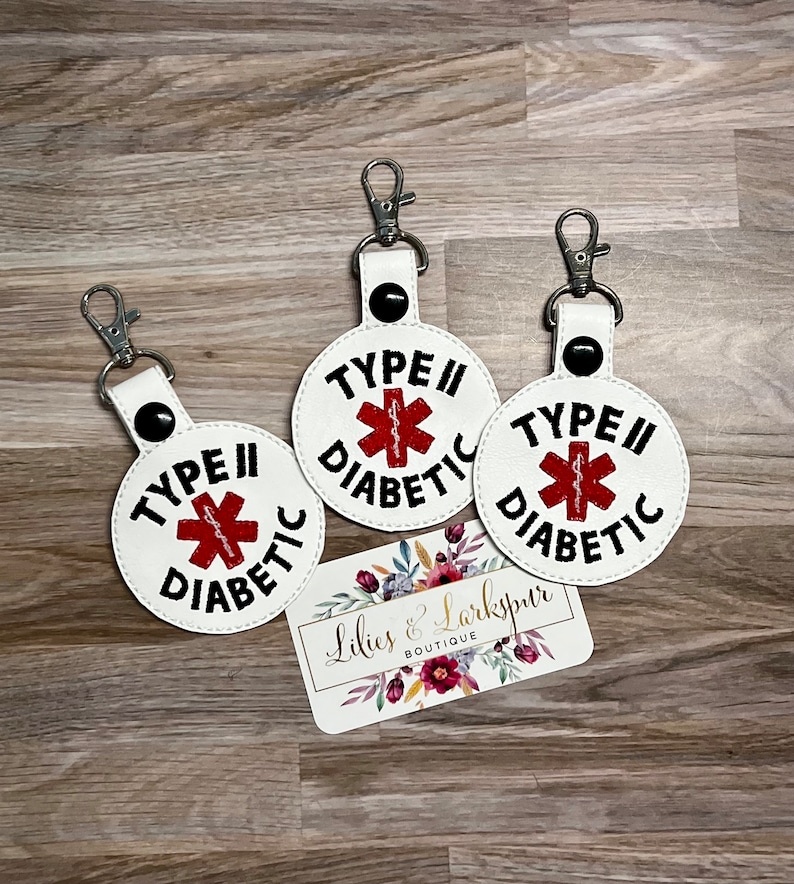 May include: Three white keychains with black text and a red medical symbol. Each keychain says "Type II Diabetic".