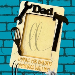 May include: A rectangular magnet with a light beige background and black tool accents. The word "Dad" is in black, with the text "Thanks for building memories with me!" in gold script. The word "Magnet" is at the top.