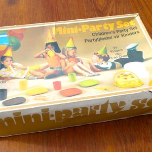 May include: A retro "Mini-Party Set" box for children, with images of kids at a party. The box includes the text "For Ages 3 and Older" and various party accessories.