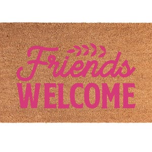 May include: A rectangular doormat made of natural brown coir fiber. The mat features the words "Friends WELCOME" in a bright pink, stylized font. The word "Friends" is arched, and the word "WELCOME" is in a straight line.