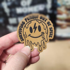 Surviving Out Of Spite Baseball Cap Patch, Laser Engraved Leatherette