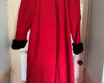 Vintage pin up style, long red coatCoat. Fits size 12. Faux fur trim.