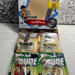 May include: A Tech Deck Big Vert Wall playset in its original packaging, accompanied by four individual Tech Deck Dude fingerboard figures, each featuring a unique character mounted on a miniature skateboard, all sealed in clear plastic blister packs.