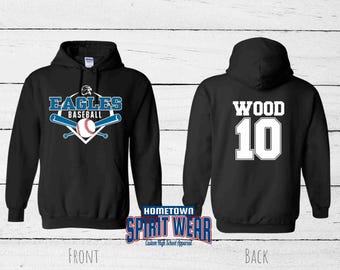 May include: A black hooded sweatshirt featuring a front graphic with the text EAGLES BASEBALL, a baseball, and two crossed bats. The back of the hoodie displays the name WOOD and the number 10 in large white lettering with a black outline.