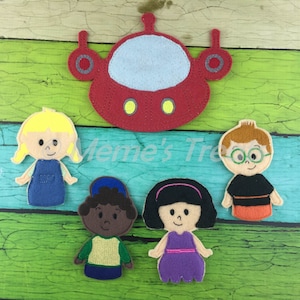 May include: A set of five felt finger puppets featuring four characters and a red spaceship. The characters include a girl with blonde hair, a boy with brown hair and glasses, a girl with black hair and a purple dress, and a boy with brown skin and a blue hat.