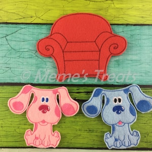 May include: A set of felt applique patches featuring Blue and Magenta from the children's television show Blue's Clues. The patches include a red armchair, a blue dog with blue spots, and a pink dog with pink spots.
