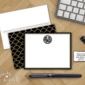 May include: A white card with a black border and gold trim. The card has a black and gold geometric pattern on the back. The front of the card has a monogram with the initials "AWS" in a circle.