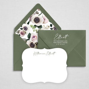 May include: A white scalloped note card with the name Katherine Elliott printed in black script, paired with a sage green envelope featuring a floral liner with white and purple anemones and roses, and a matching sage green envelope with return address.