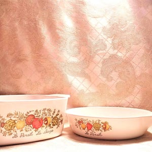 May include: Two white ceramic baking dishes with floral designs and the text "Le Persil, la Sauge" and "Le Persil".