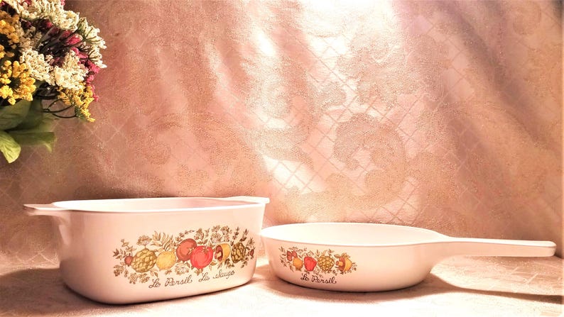 May include: Two white ceramic baking dishes with floral designs and the text "Le Persil, la Sauge" and "Le Persil".