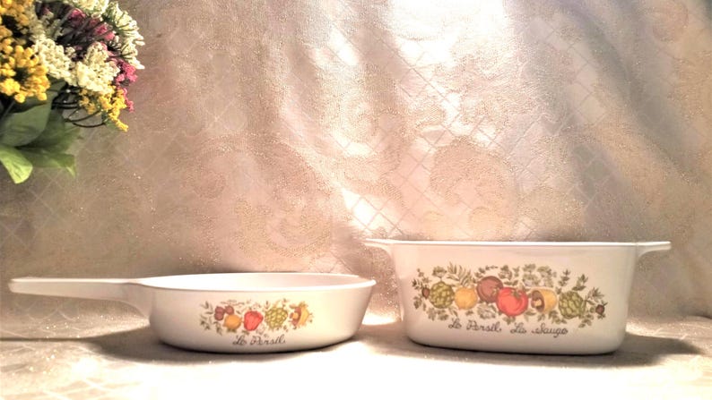 May include: Two white ceramic casserole dishes with a floral design and the text "Le Parfait de la cuisine" and "Le Parfait".