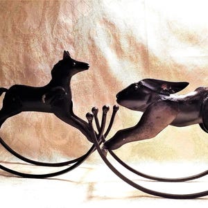 May include: Black metal rocking horse and rabbit figurines on a white background.